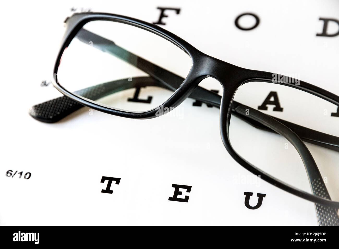 Glasses on eye chart Stock Photo Alamy