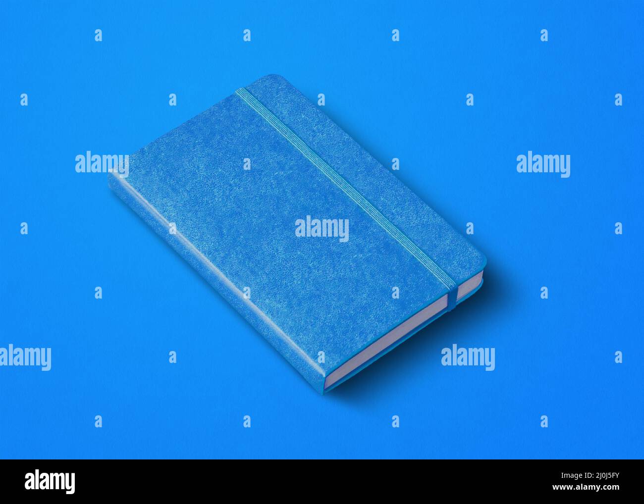 Blue closed notebook isolated on color background Stock Photo
