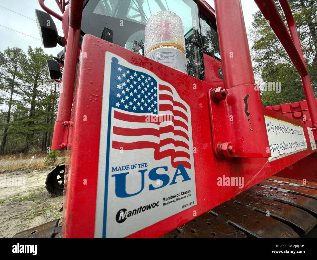 Augusta, Ga USA - 03 19 22: Manitowoc Red Crane Construction scene cloudy rainy day made in USA sign side view Stock Photo