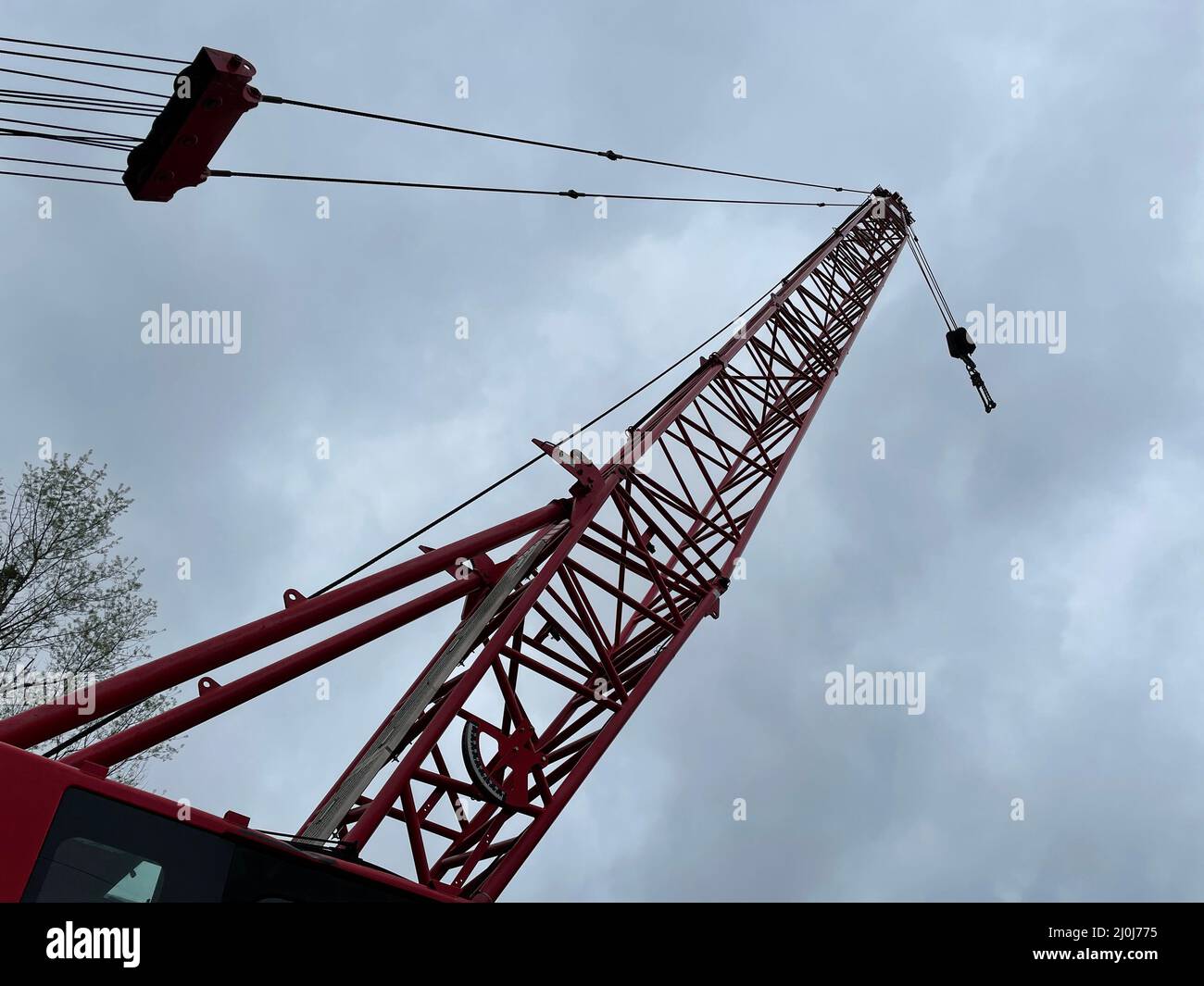 Augusta, Ga USA - 03 19 22: Manitowoc Red Crane Construction scene cloudy rainy day looking up at boom Stock Photo