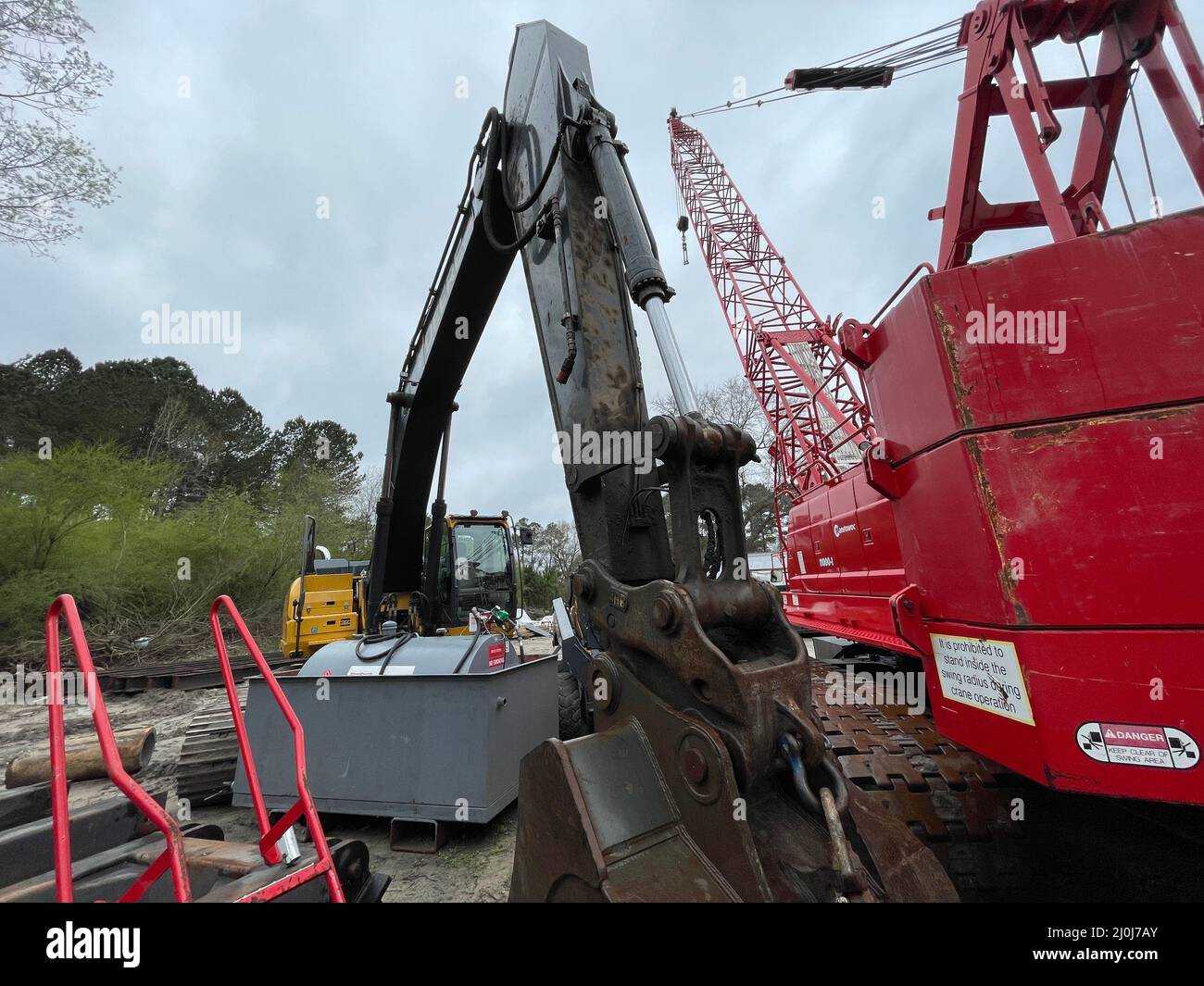 Augusta, Ga USA 03 19 22 Manitowoc Red Crane Construction scene cloudy rainy day side view