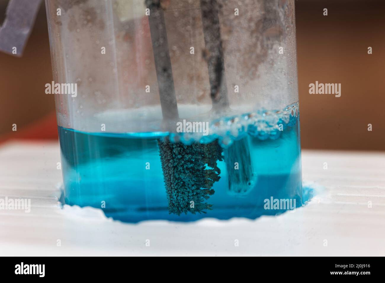 Microscale electrolysis of copper chloride solution for school science in the UK Stock Photo