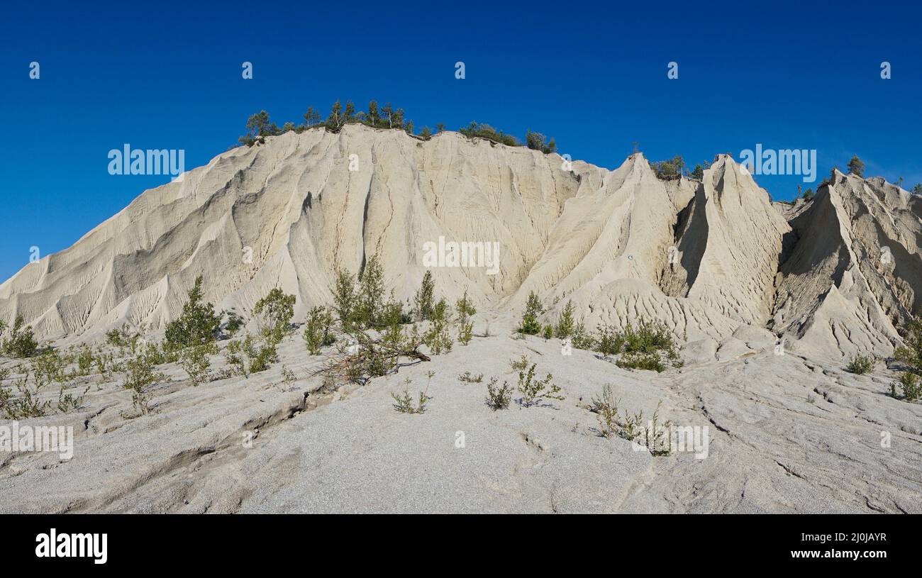 Abstract view of limestone and sandstone mountains with sharp edges under a cloudless sky Stock Photo