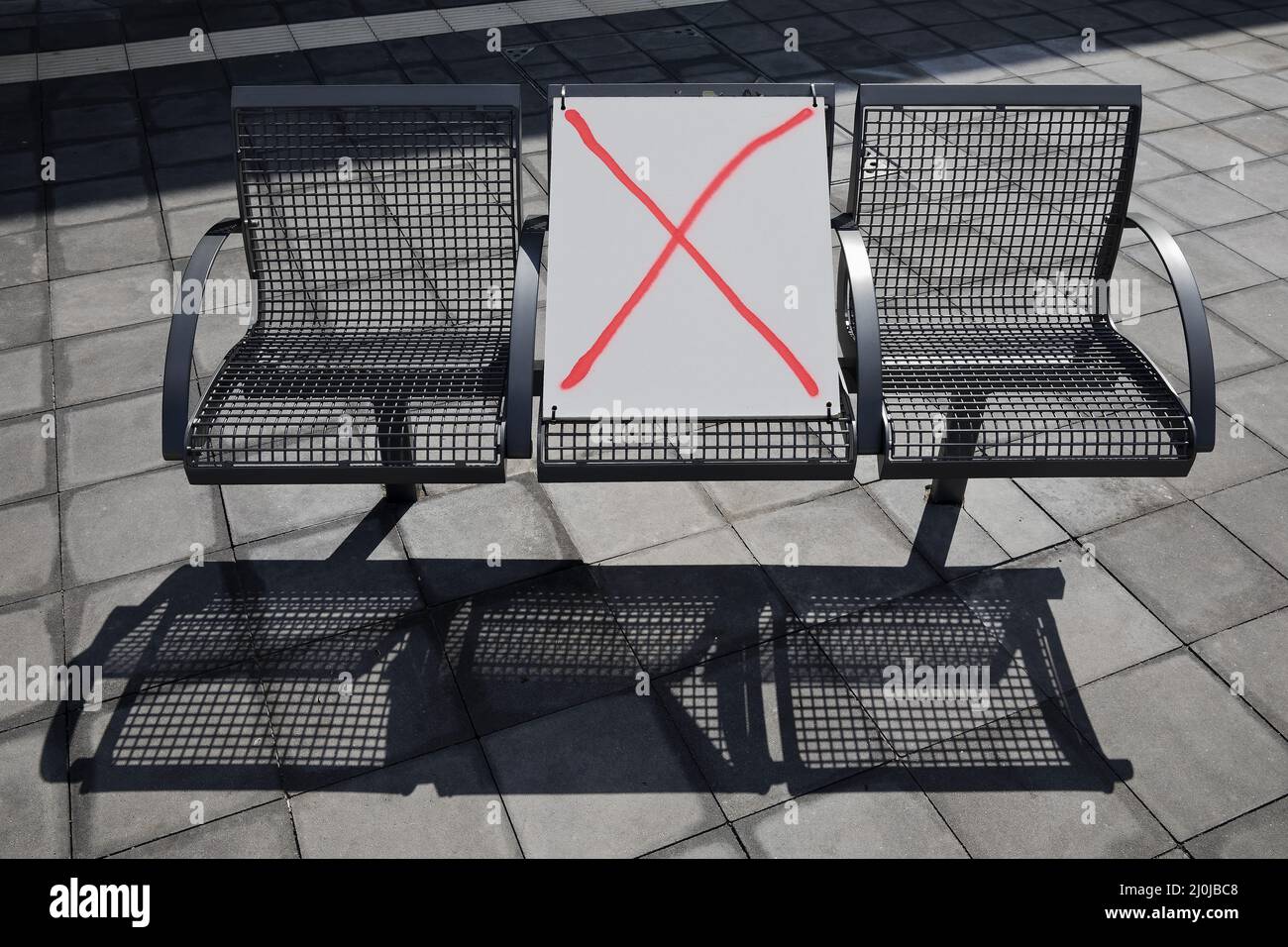 Corona distance rule on a bench in public space in spring 2021, Central Bus Station, Berlin, Germany Stock Photo