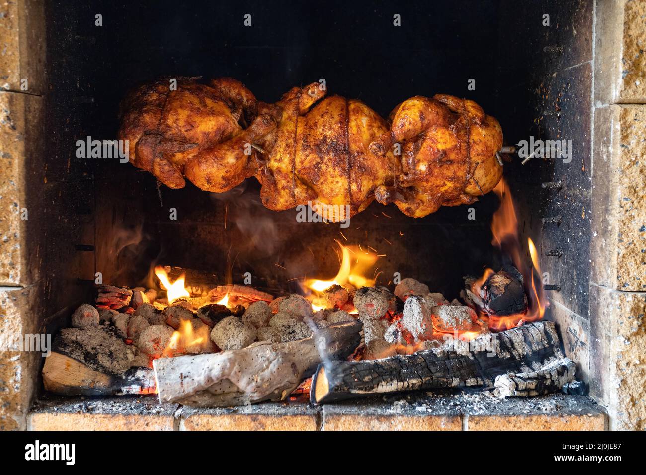 Chicken roasting on a spit Stock Photo
