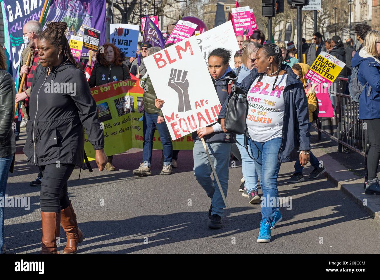 Anti Racism protest on the streets of London. Two females holding a black lives matter sign. London - 19th March 2022 Stock Photo