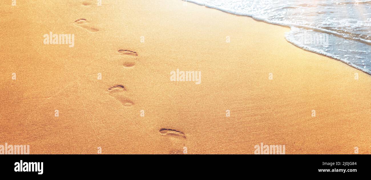 Walking on the beach, leaving footprints in the sand Stock Photo - Alamy