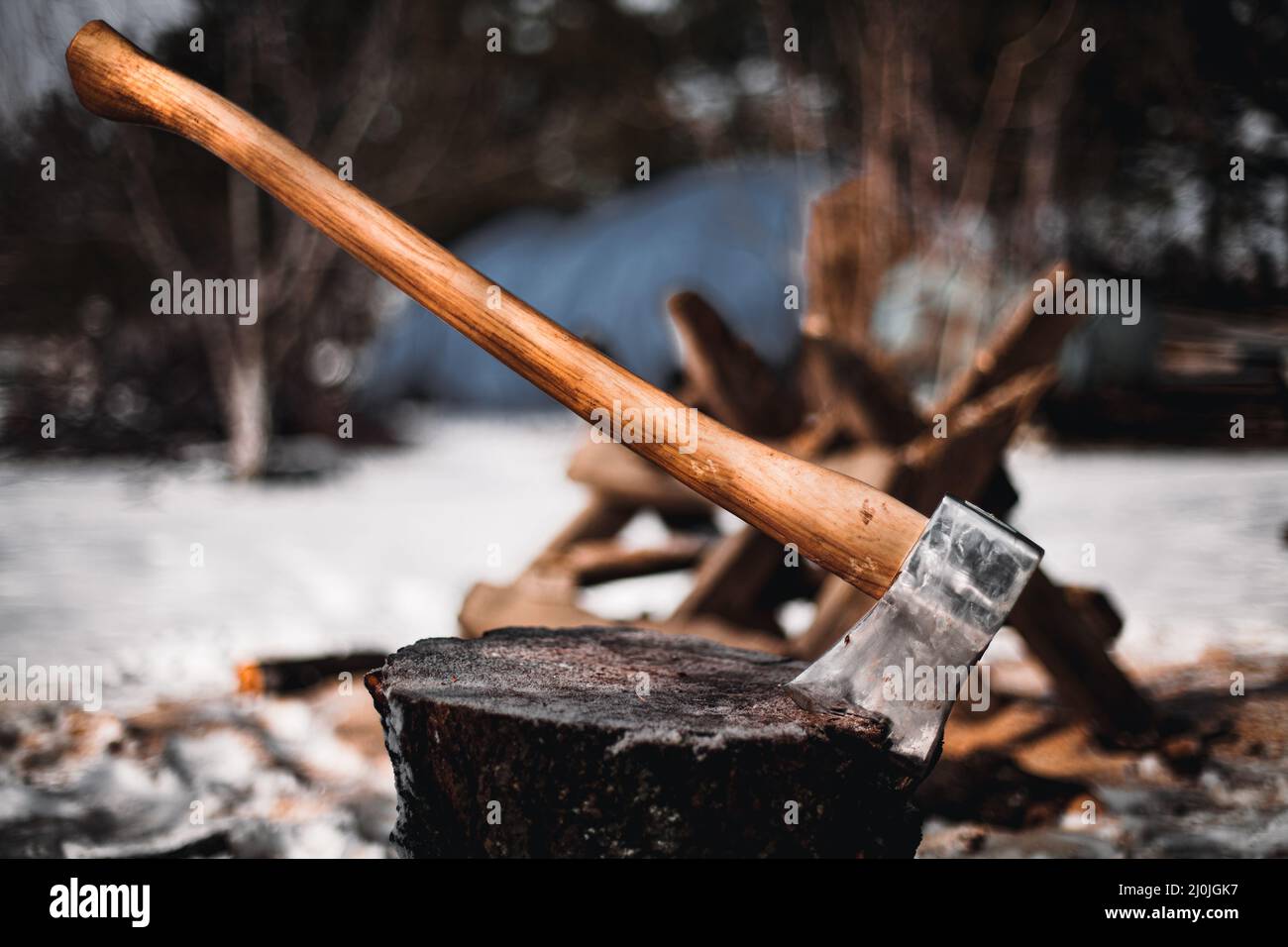 Axe in the log. Ax stuck in a tree stump Stock Photo