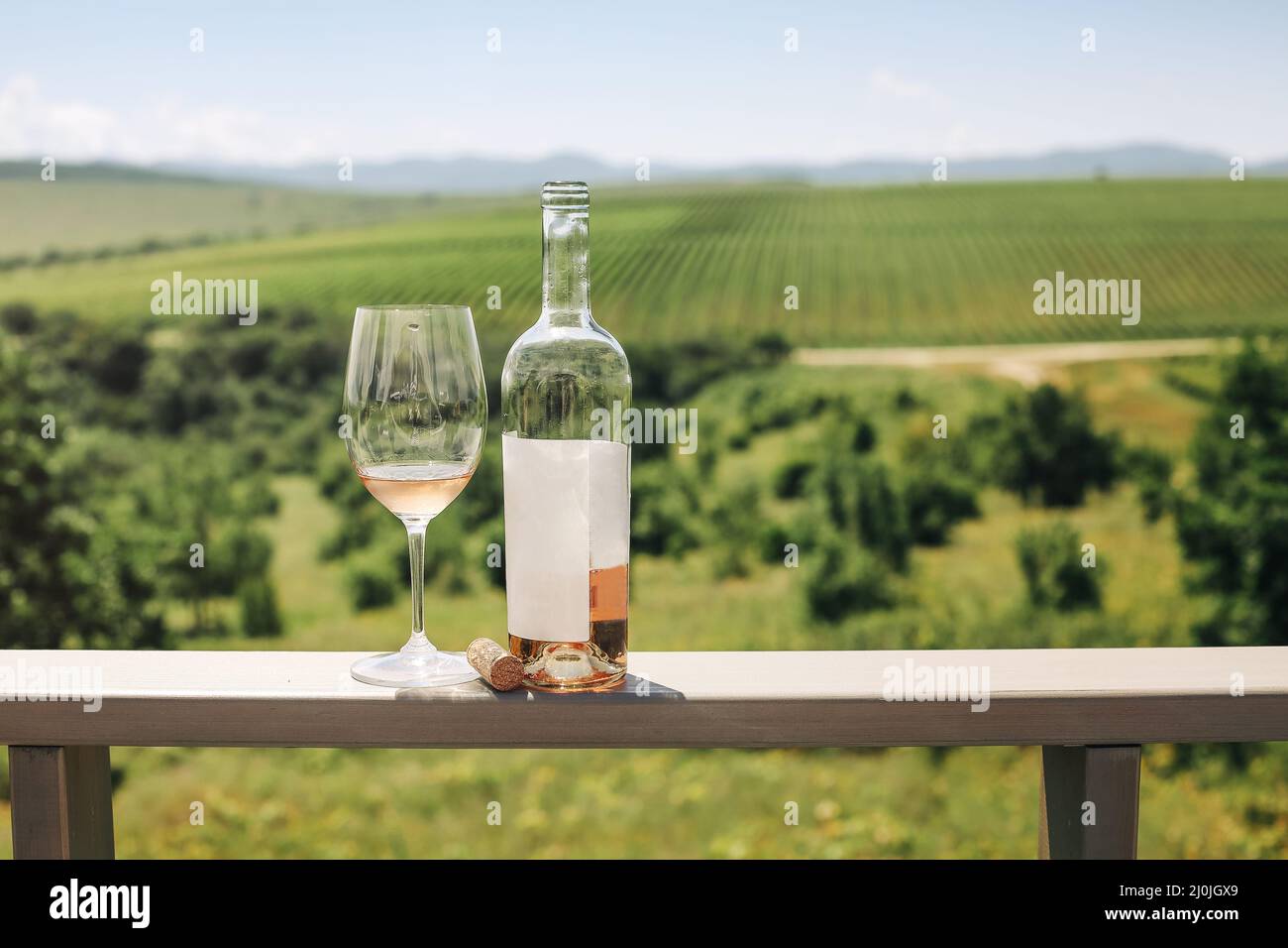 Rose wine bottle, grape vine, glass and cork Stock Photo - Alamy