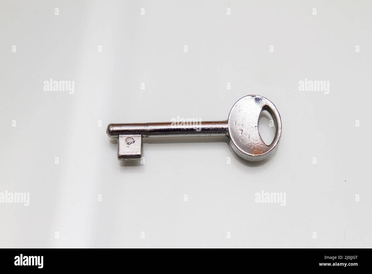 Silver Old Key old silver key on a white table in Rio de Janeiro Stock Photo - Alamy