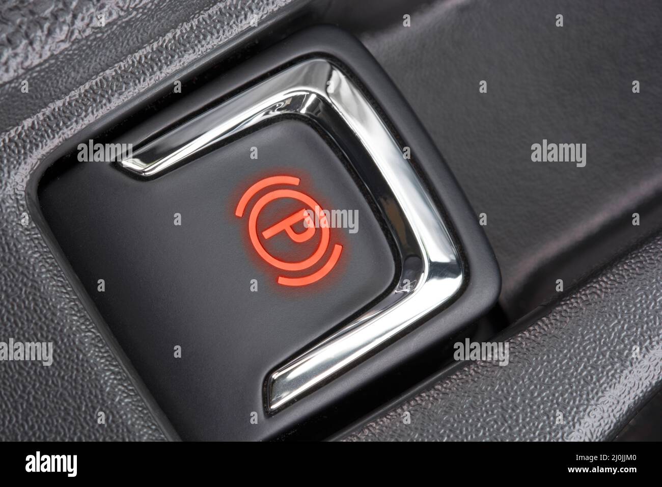 Detail image of the activated electric parking brake of a modern car. Stock Photo