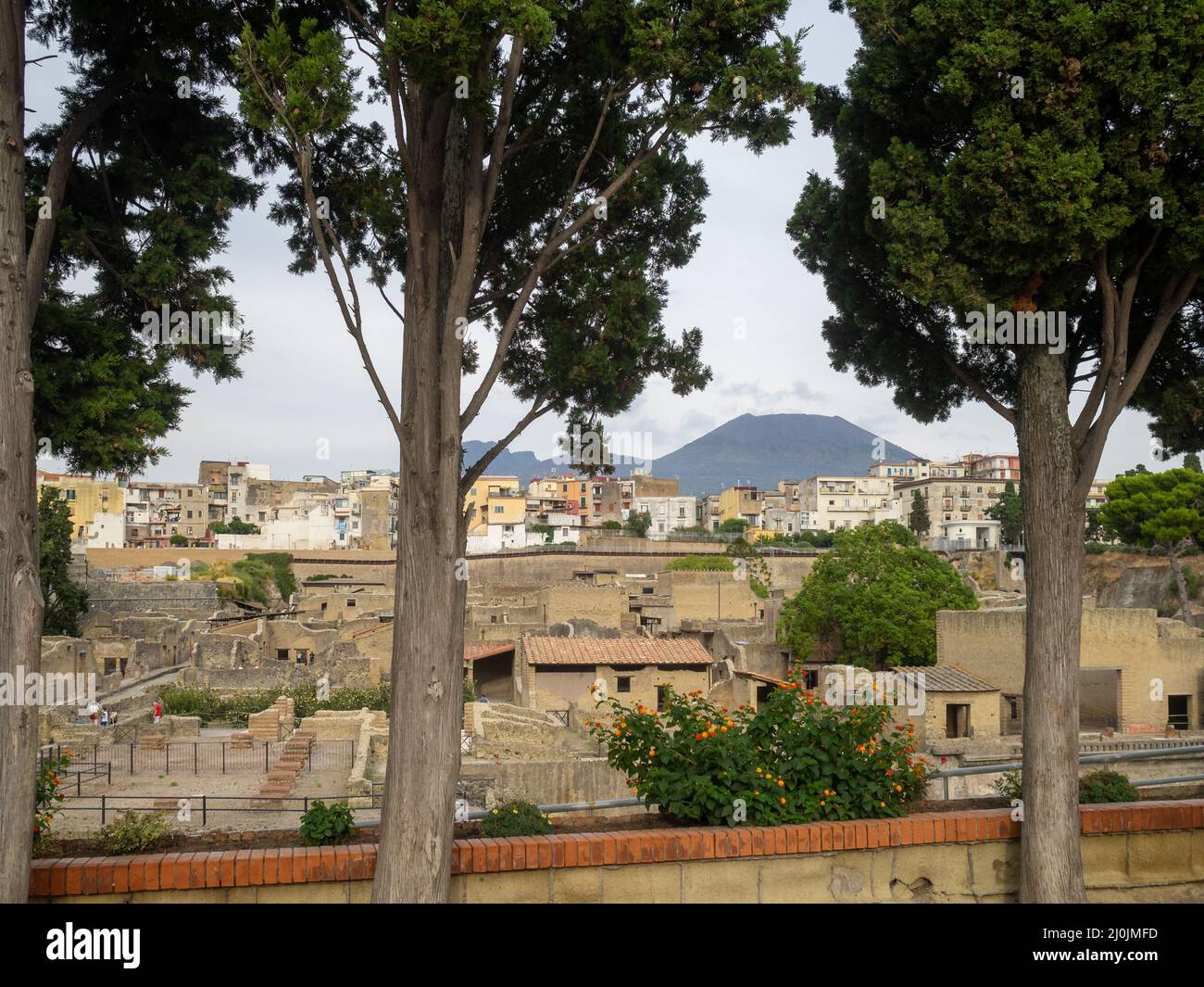 View of Herculaneum ruins between the modern city, with Mount Vesuvius in background Stock Photo