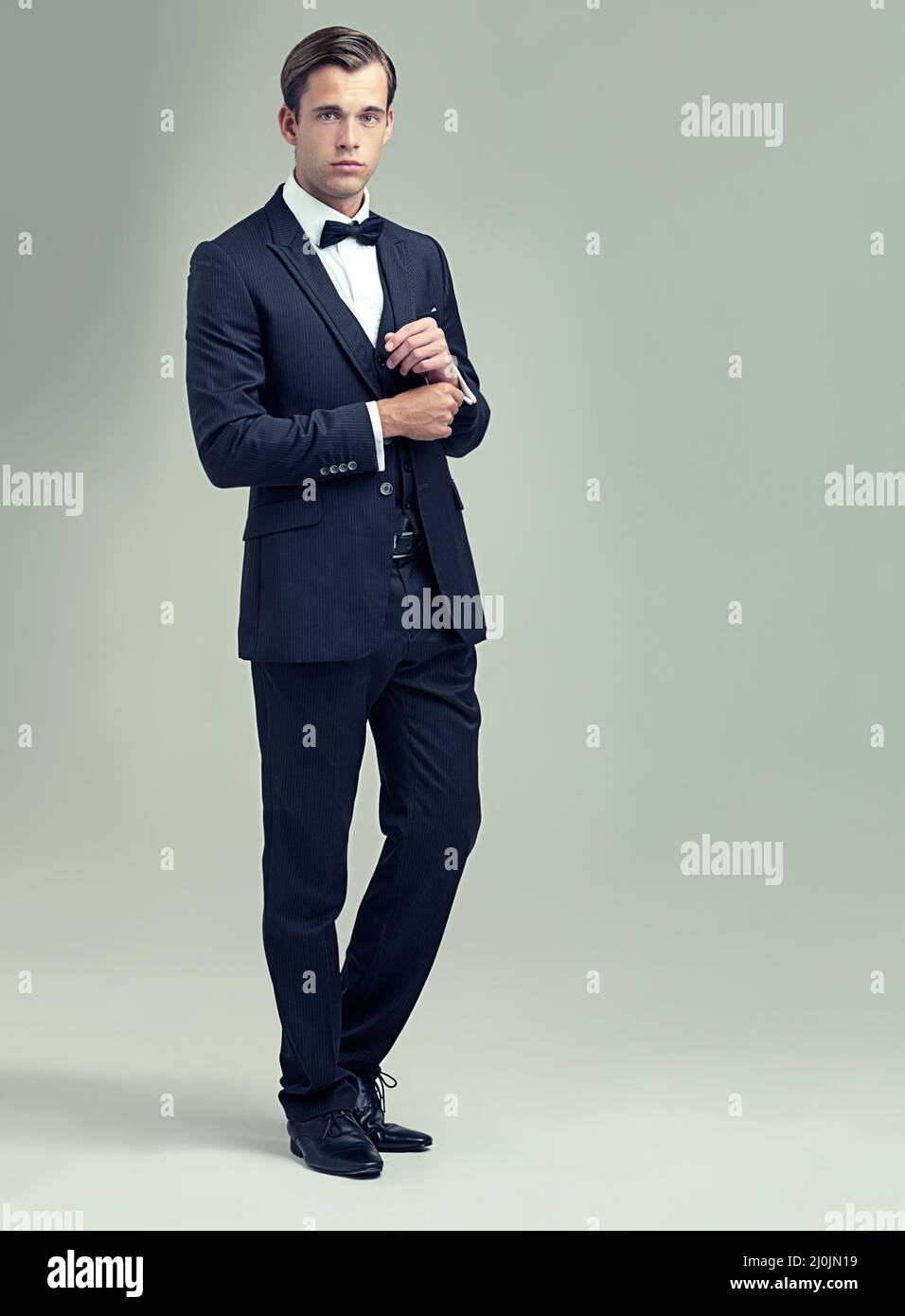 Confident and classic. A full length studio shot of a handsome young man in a stylish vintage suit. Stock Photo