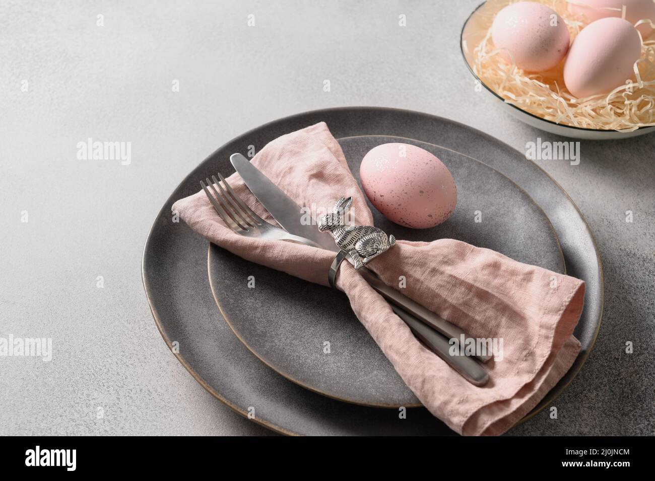 Easter dinner with pink egg, elegance table setting. Top view. Copy space. Stock Photo