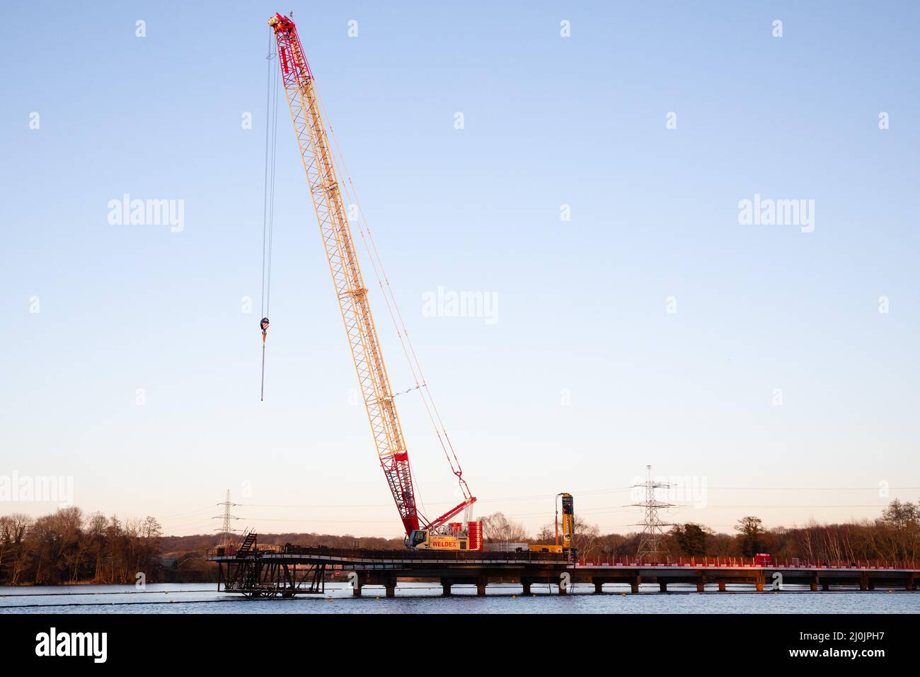Harefield, UK. 27th February, 2022. Construction works for the HS2 Colne Valley Viaduct, which will become the UK's longest railway bridge, are pictured at HOAC Lake (Harefield Lake No. 2). A viaduct requiring 292 piles is currently being constructed to carry HS2 across lakes and watercourses in the Colne Valley Regional Park. Credit: Mark Kerrison/Alamy Live News Stock Photo