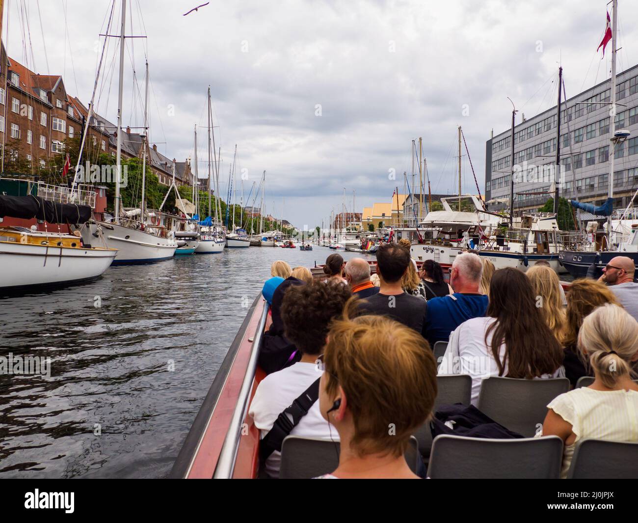 Copenhagen, Denmark - July,  2021: Tourists in the sightseeing tour boat in the canals of  Copenhagen. Europe Stock Photo