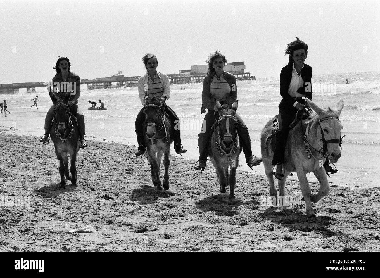 The Nolan sisters, who are appearing at the Winter Gardens, enjoy themselves riding donkeys on the sands at Blackpool. 17th July 1980. Stock Photo