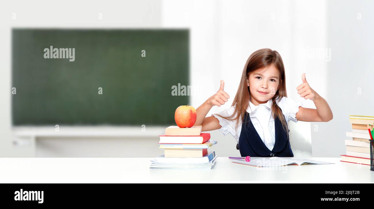 Happy and cute teen school girl showing thumbs up Stock Photo - Alamy