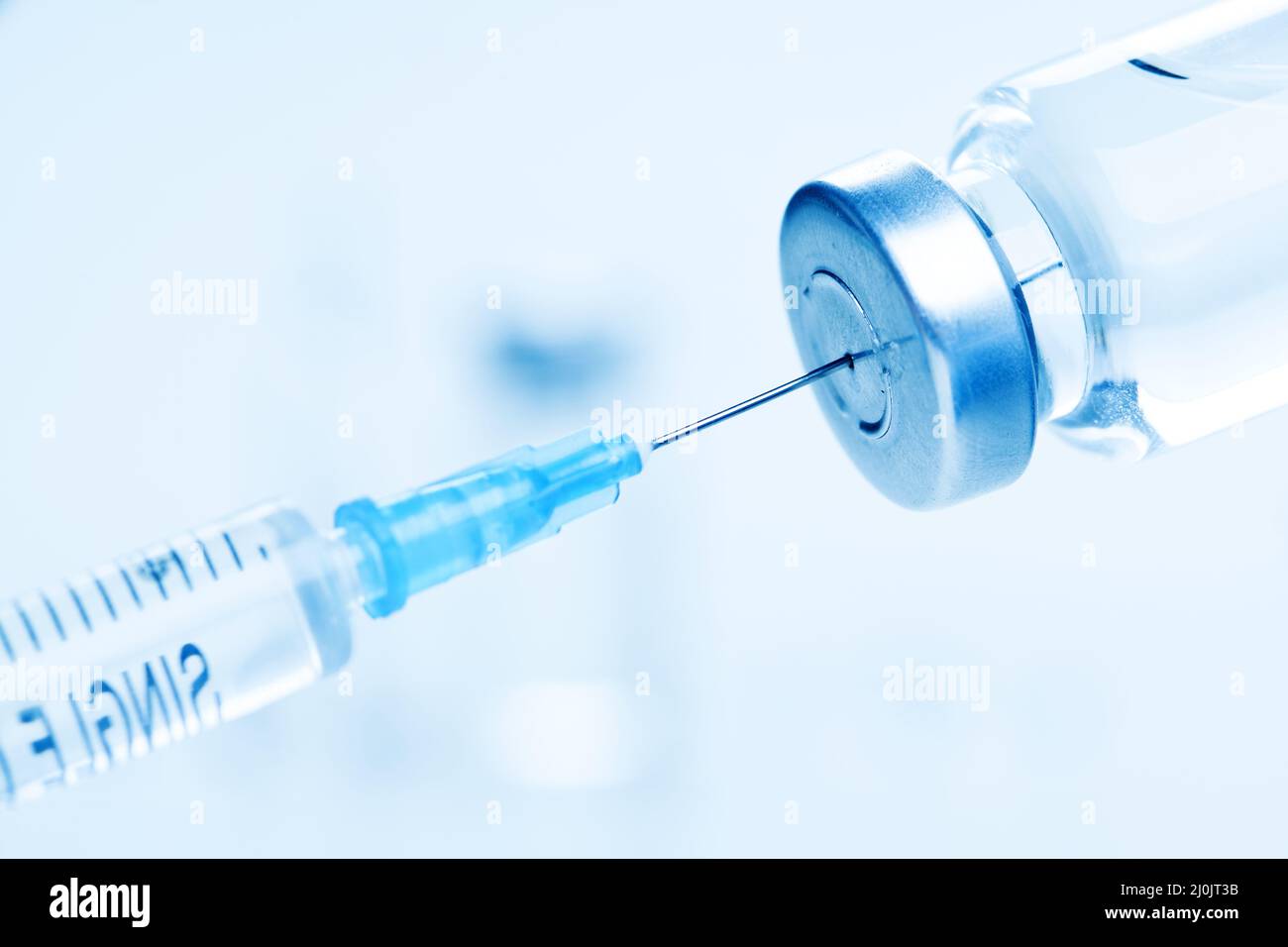 Medical syringe with a needle and a bollte with vaccine. Stock Photo