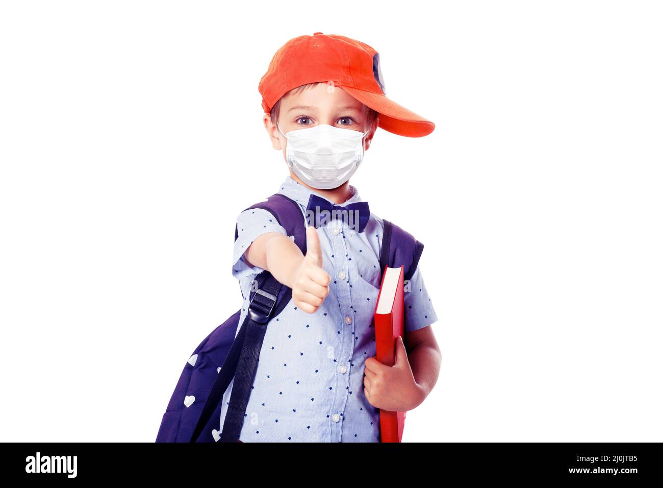 Young boy with protection mask against corona virus at school. Stock Photo