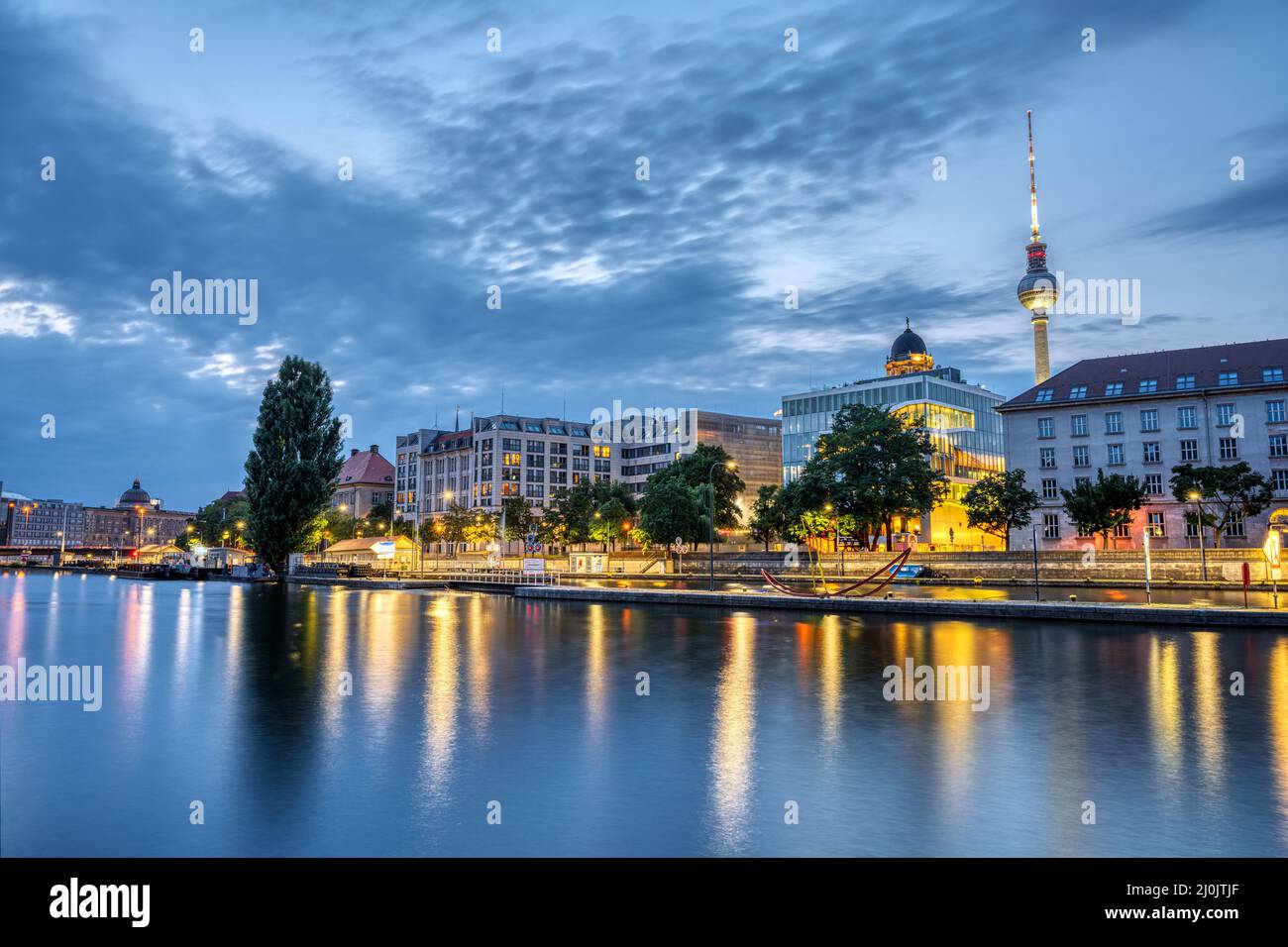 The river Spree in downtown Berlin with the famous TV Tower at dusk Stock Photo