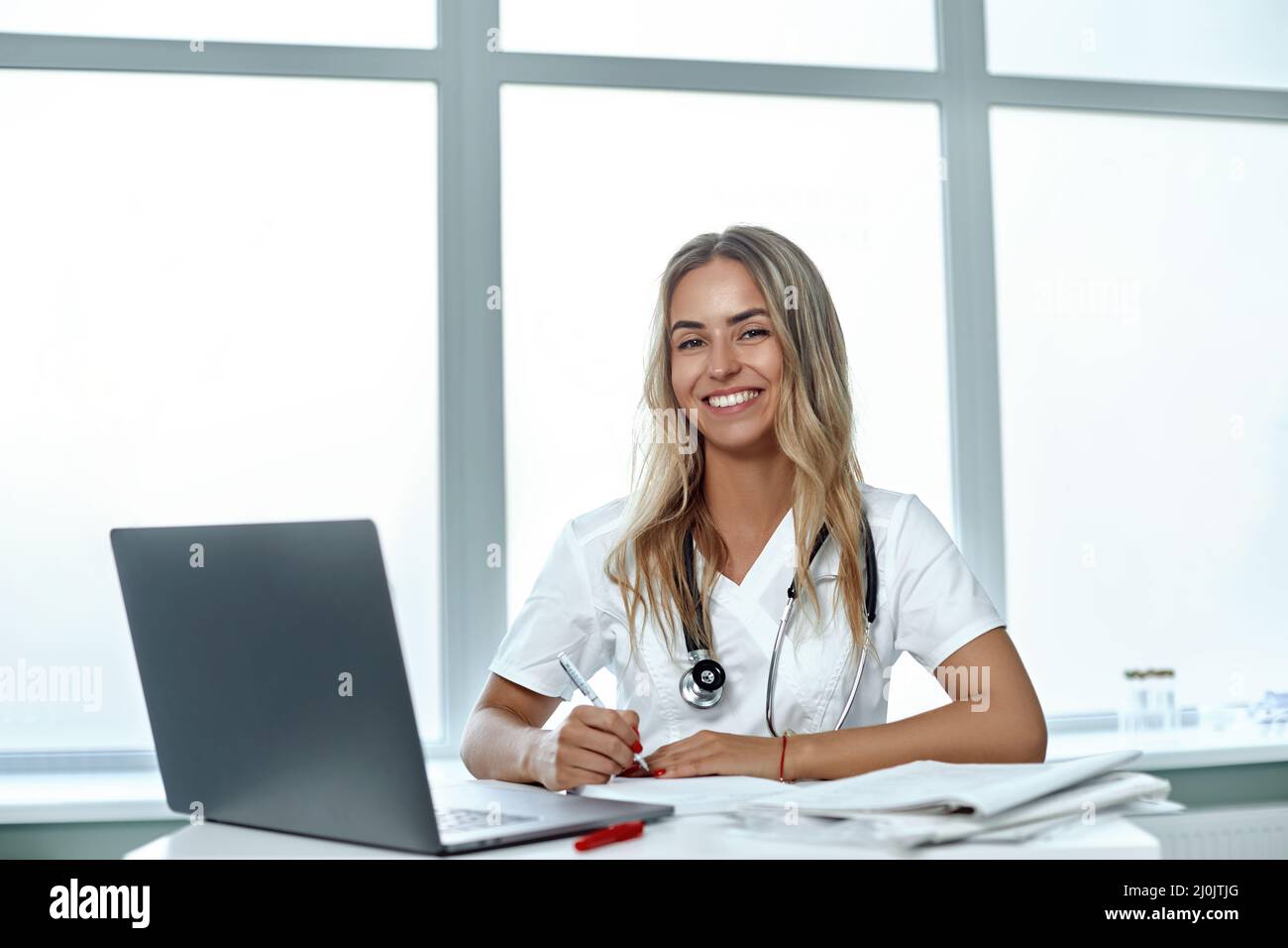 Female doctor working with her laptop in medical office Stock Photo