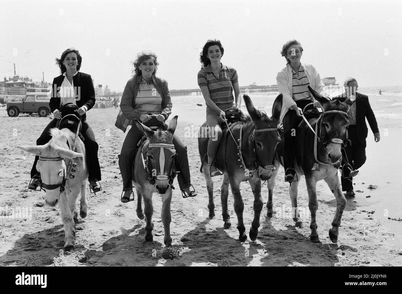 The Nolan sisters, who are appearing at the Winter Gardens, enjoy themselves riding donkeys on the sands at Blackpool. 17th July 1980. Stock Photo