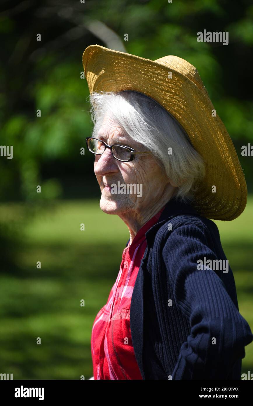 Elderly woman has wrinkled face and lines caused by exposure to the sun ...
