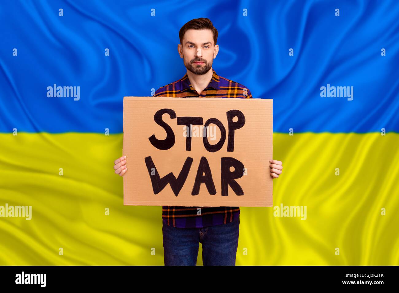 Photo image of young activist guy ask international diplomacy help Ukraine  in struggle against russia terrorism repression hold poster yellow blue  Stock Photo - Alamy