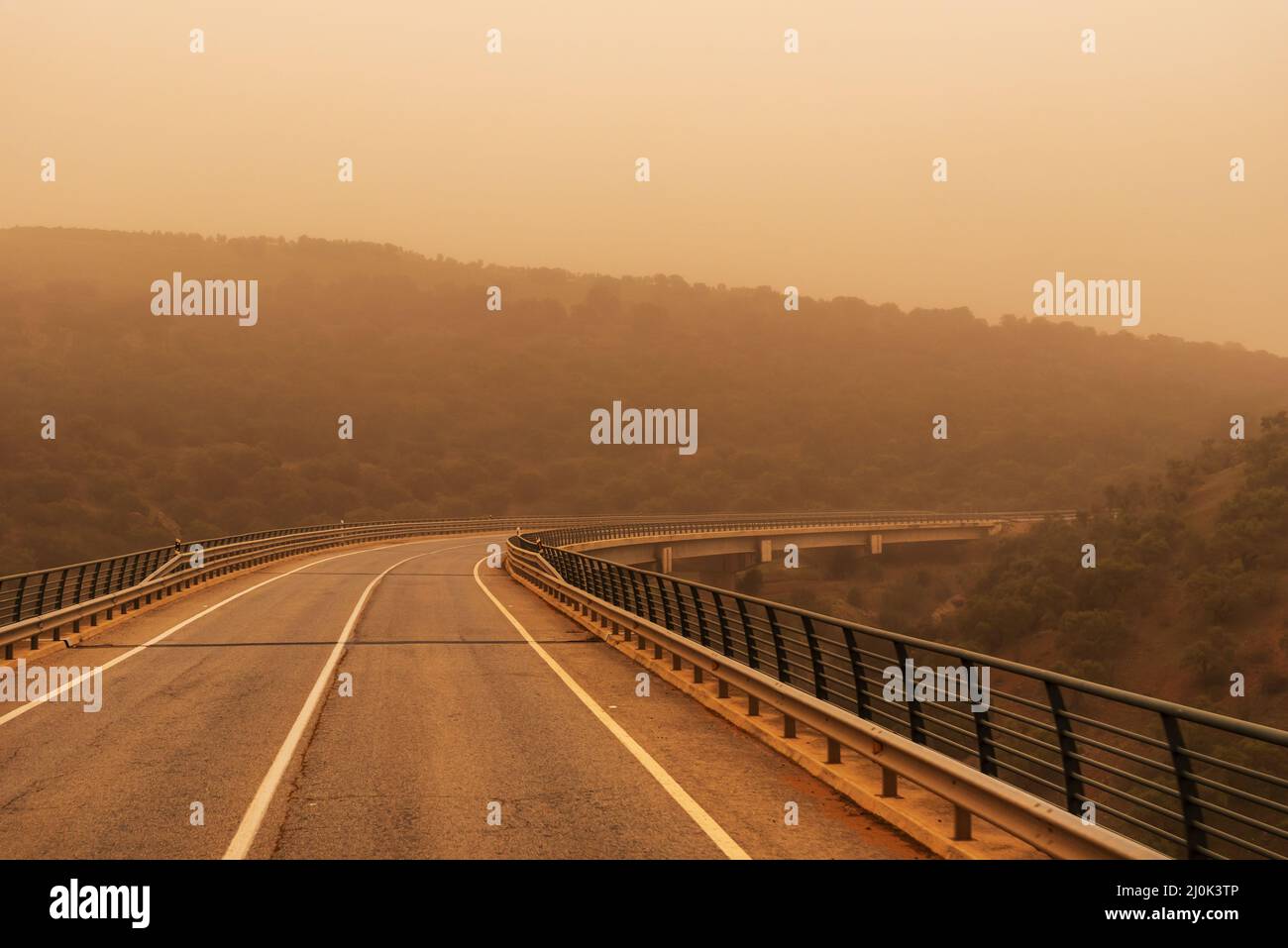 Viaduct between mountains with a lot of saharan dust in the environment (calima) Stock Photo