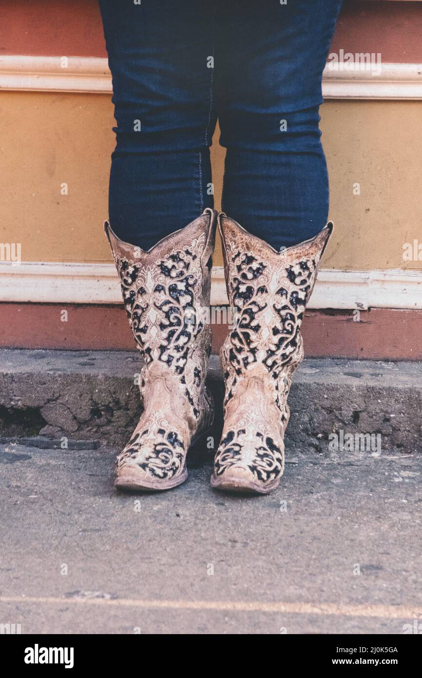 female feet wearing cowboy boots Stock 