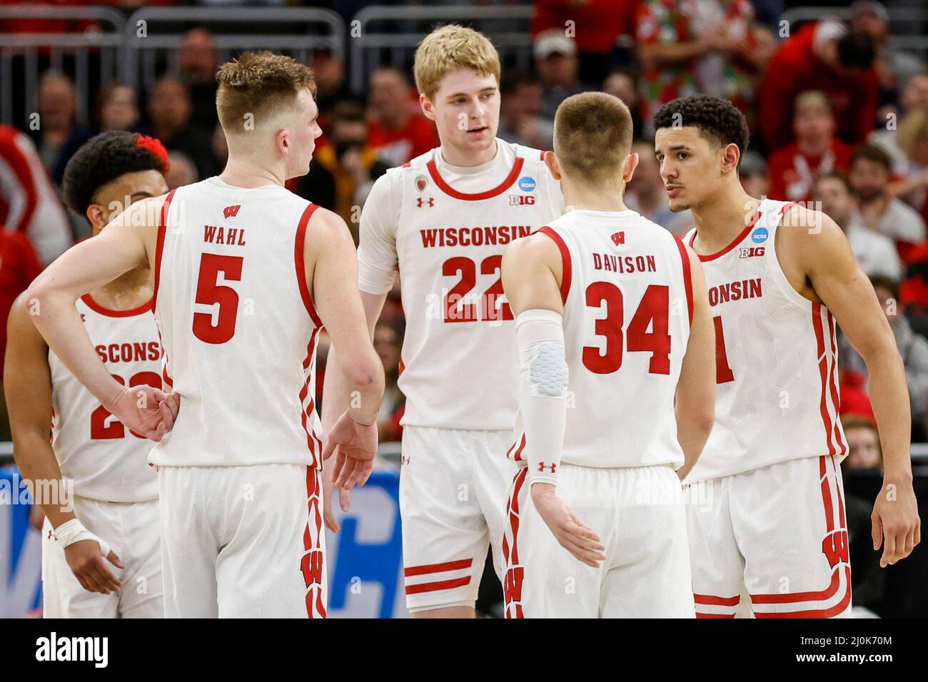 Milwaukee, WI, USA. 18th Mar, 2022. Wisconsin Badgers guard Johnny Davis (1), guard Brad Davison (34), forward Tyler Wahl (5), guard Chucky Hepburn (23), and forward Steven Crowl (22) huddle up during the NCAA Men's March Madness Tournament basketball game between the Colgate Raiders and the Wisconsin Badgers at the Fiserv Forum in Milwaukee, WI. Darren Lee/CSM/Alamy Live News Stock Photo