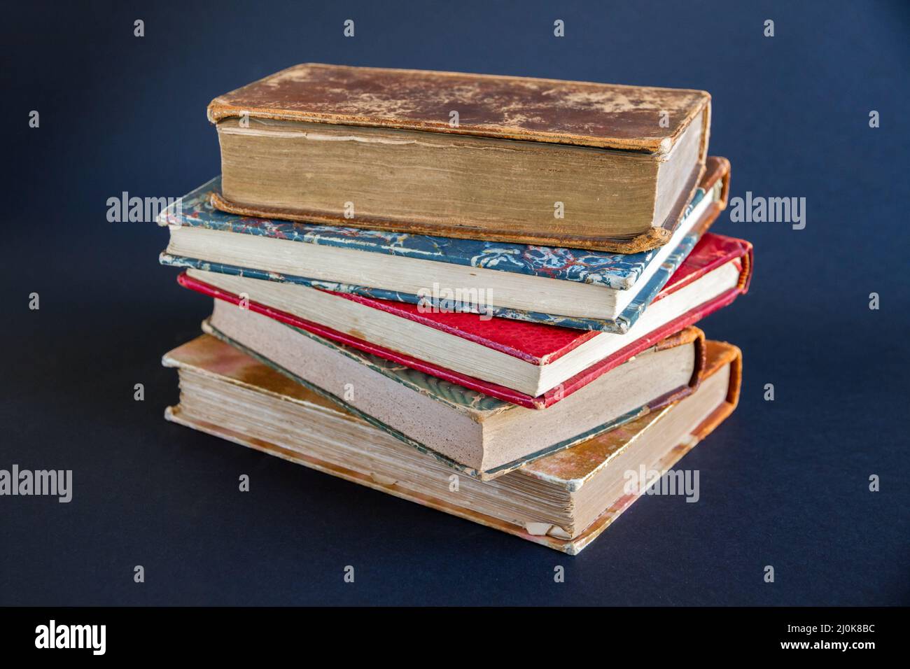Stack of old books on dark background Stock Photo