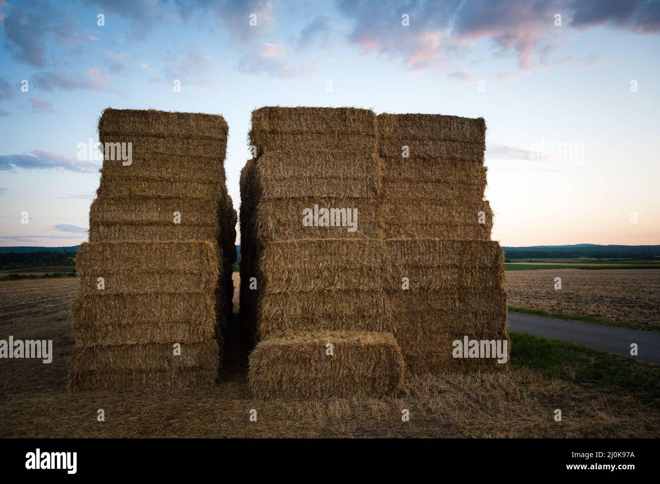 Hale bales piled up in a farmland in the countryside, blue sky, copy space Stock Photo