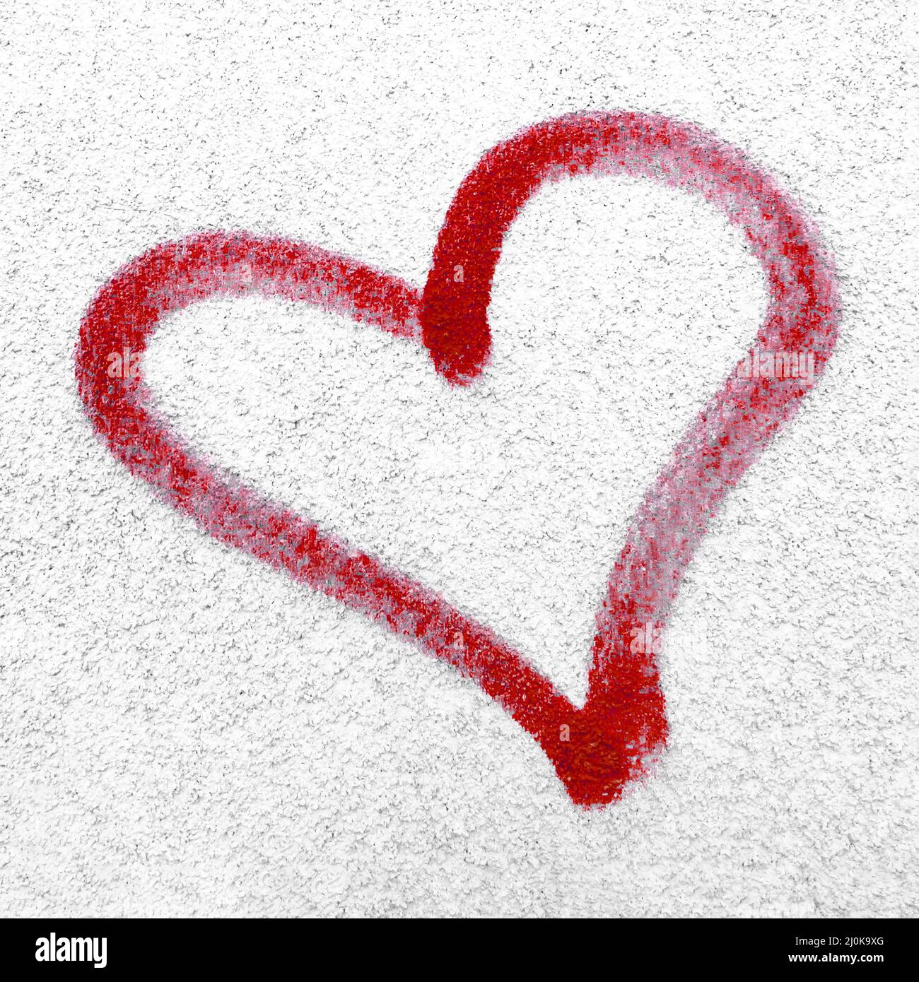 Red heart hand drawn on concrete wall Stock Photo