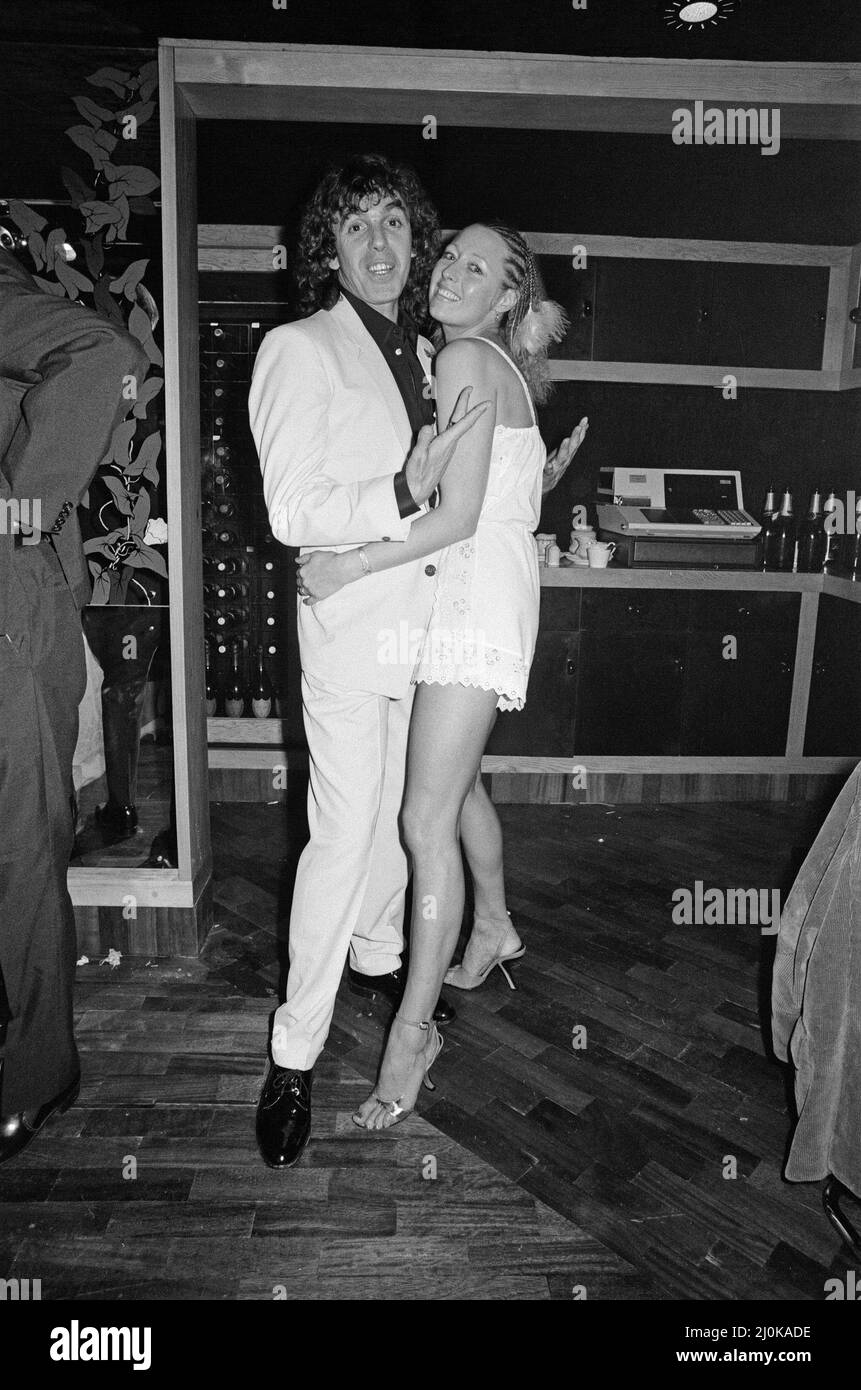 Peter Stringfellow, owner of the new nightclub Stringfellows in Covent Garden, pictured at the nightclub with a guest. London. 1st August 1980. Picture with his wife Coral Stock Photo