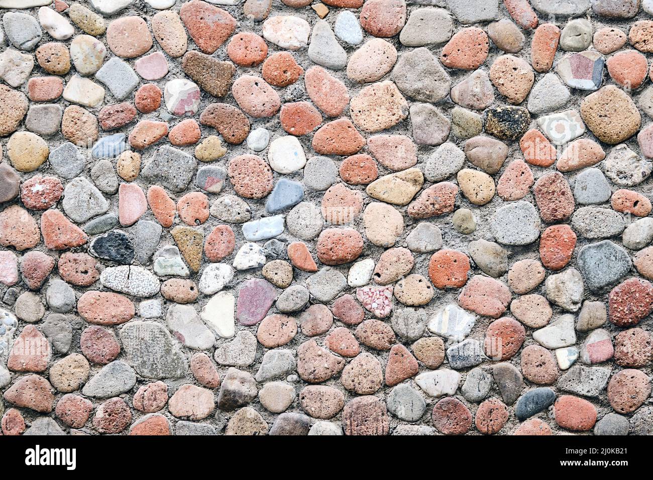 Background from a wall made of pebbles Stock Photo