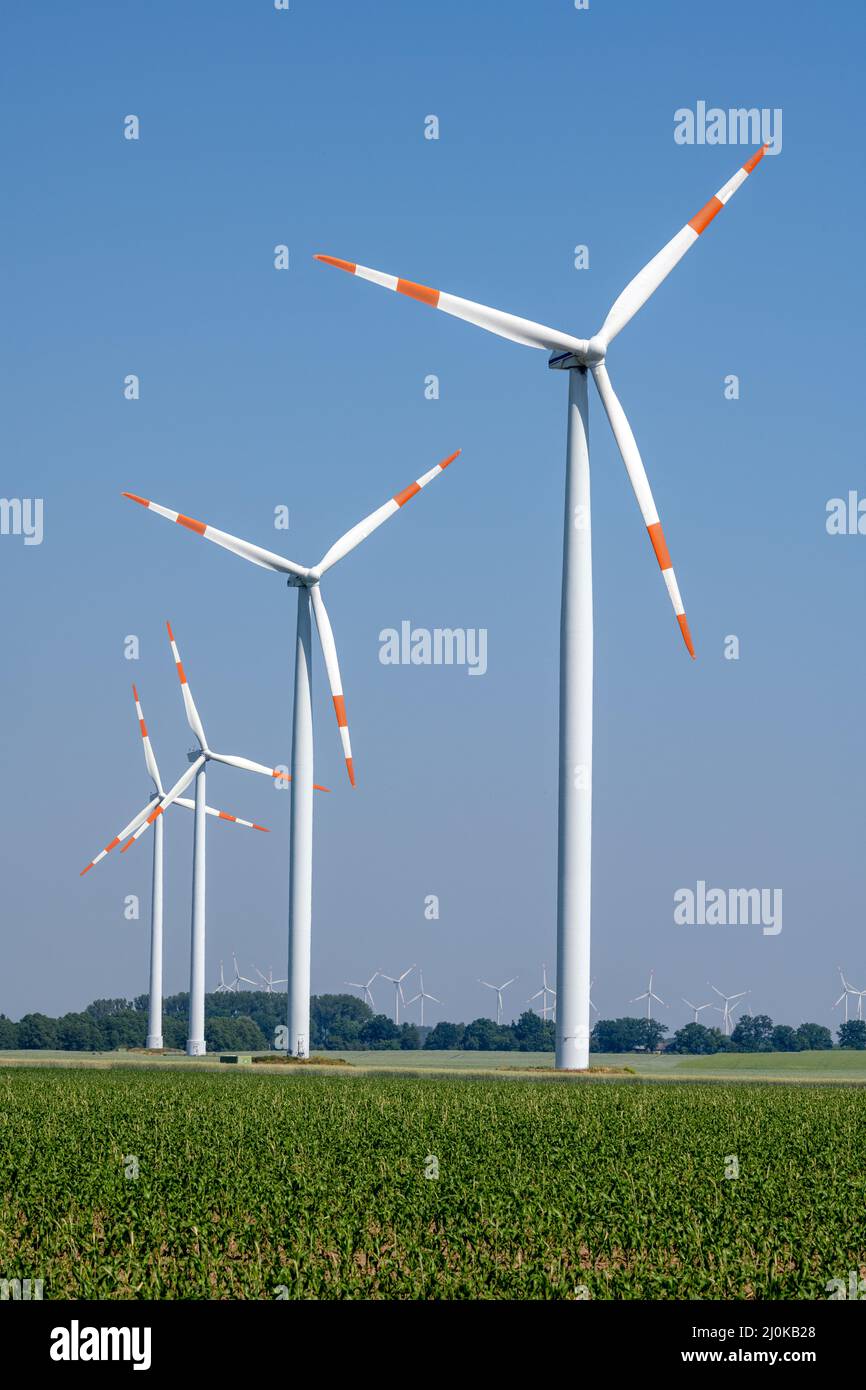 Modern wind turbines in front of a blue sky seen in Germany Stock Photo