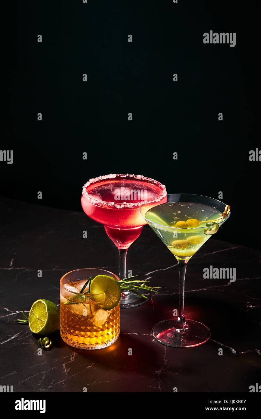Alcoholic and non-alcoholic cocktails on a dark marble table. Summer refreshments Stock Photo