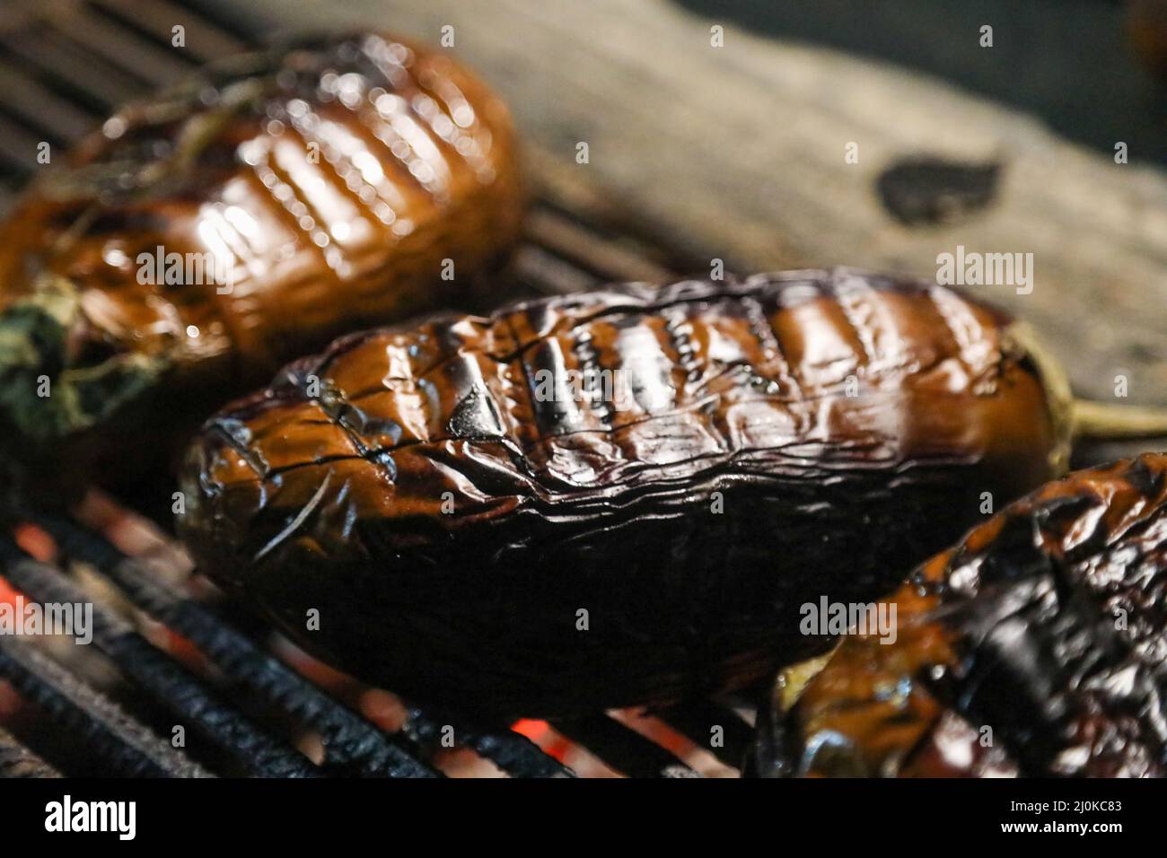 Eggplant group being cooked on a fireplace BBQ grill at the camping