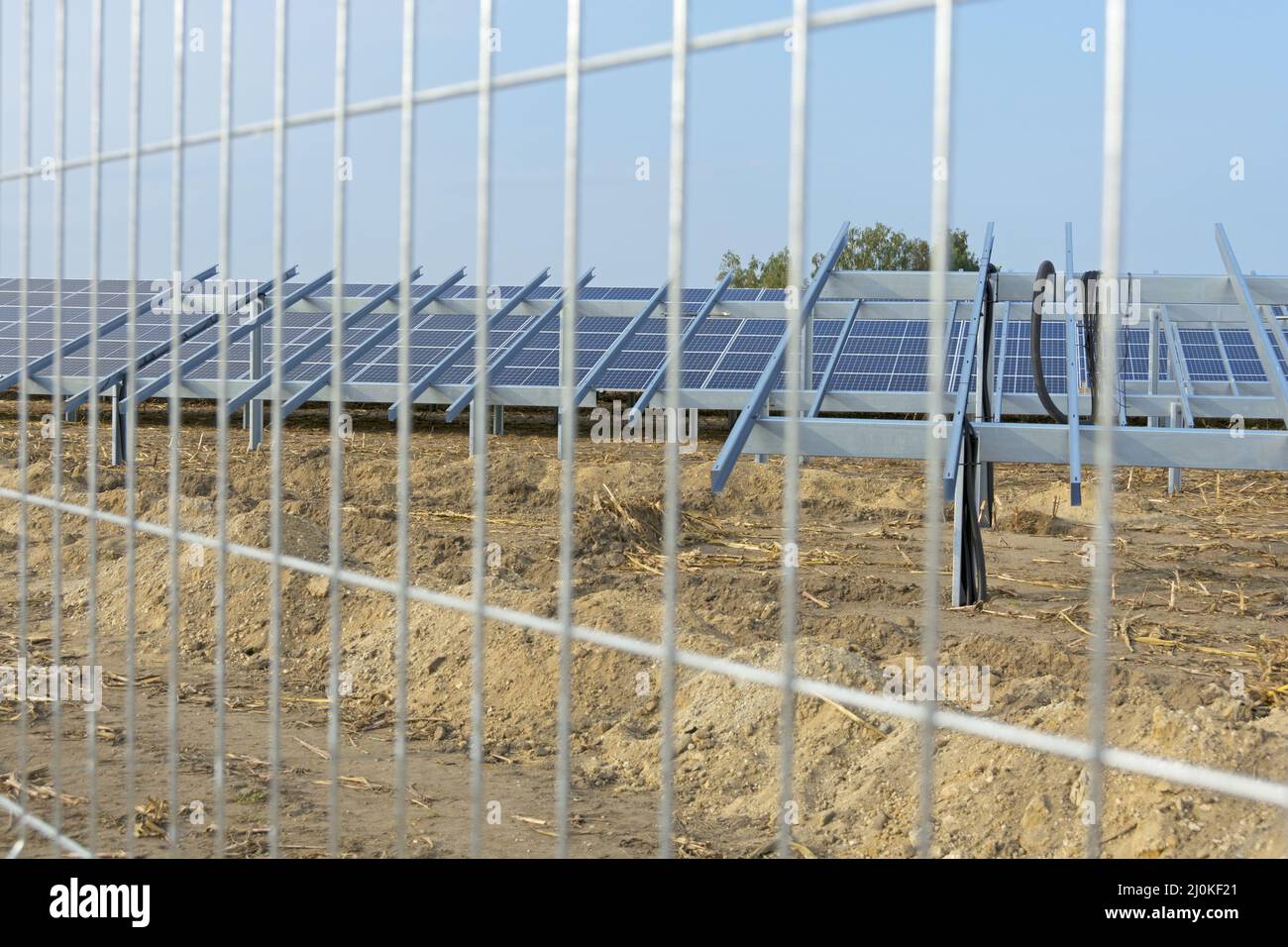 View through fence on solar park construction site Stock Photo