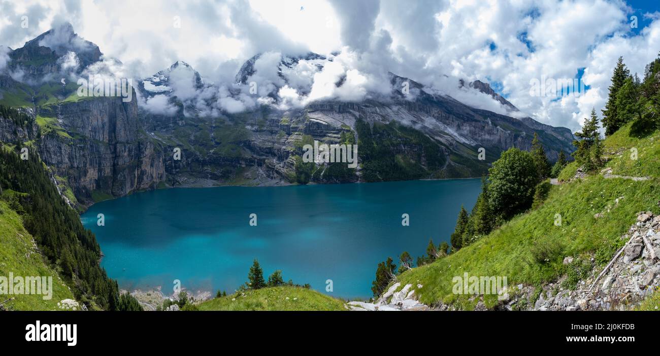 Attractive summer morning on the unique Oeschinensee Lake. Wonderful outdoor scene in the Swiss Alps with Bluemlisalp mountain, Stock Photo