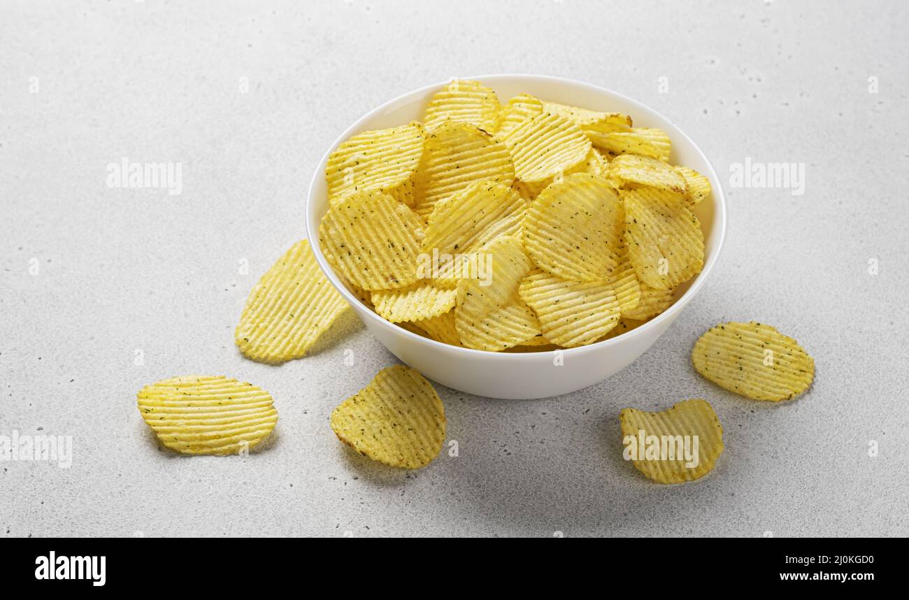 Corrugated potato chips in bowl, top view Stock Photo - Alamy