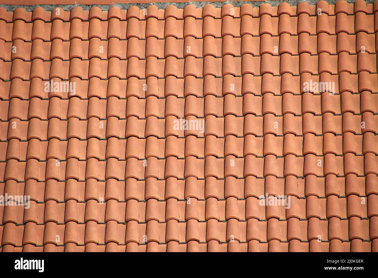 Red tiled shingles roof texture background Stock Photo - Alamy