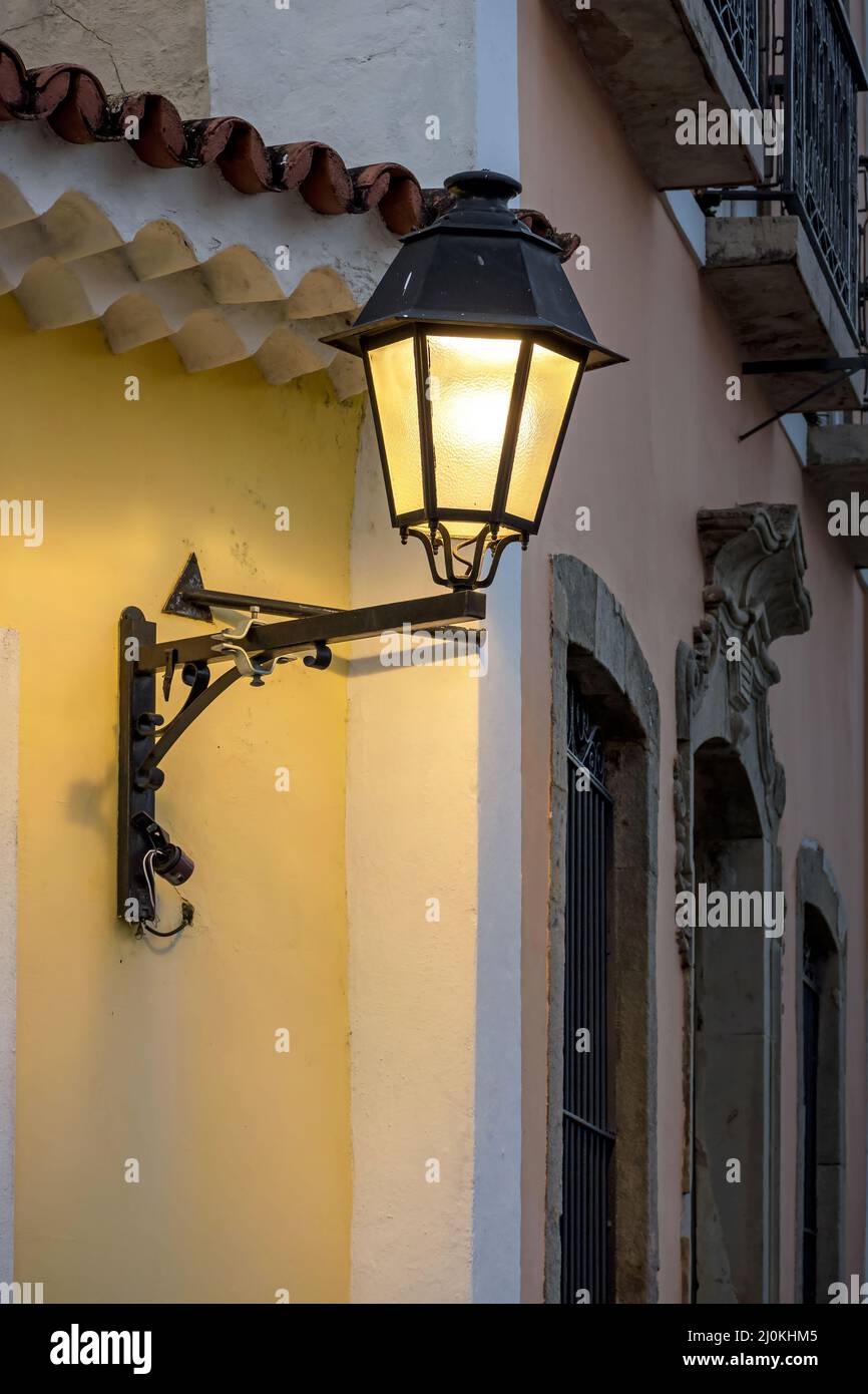Old metal lanterns and colorful facade of a colonial house in the historic Pelourinho district Stock Photo
