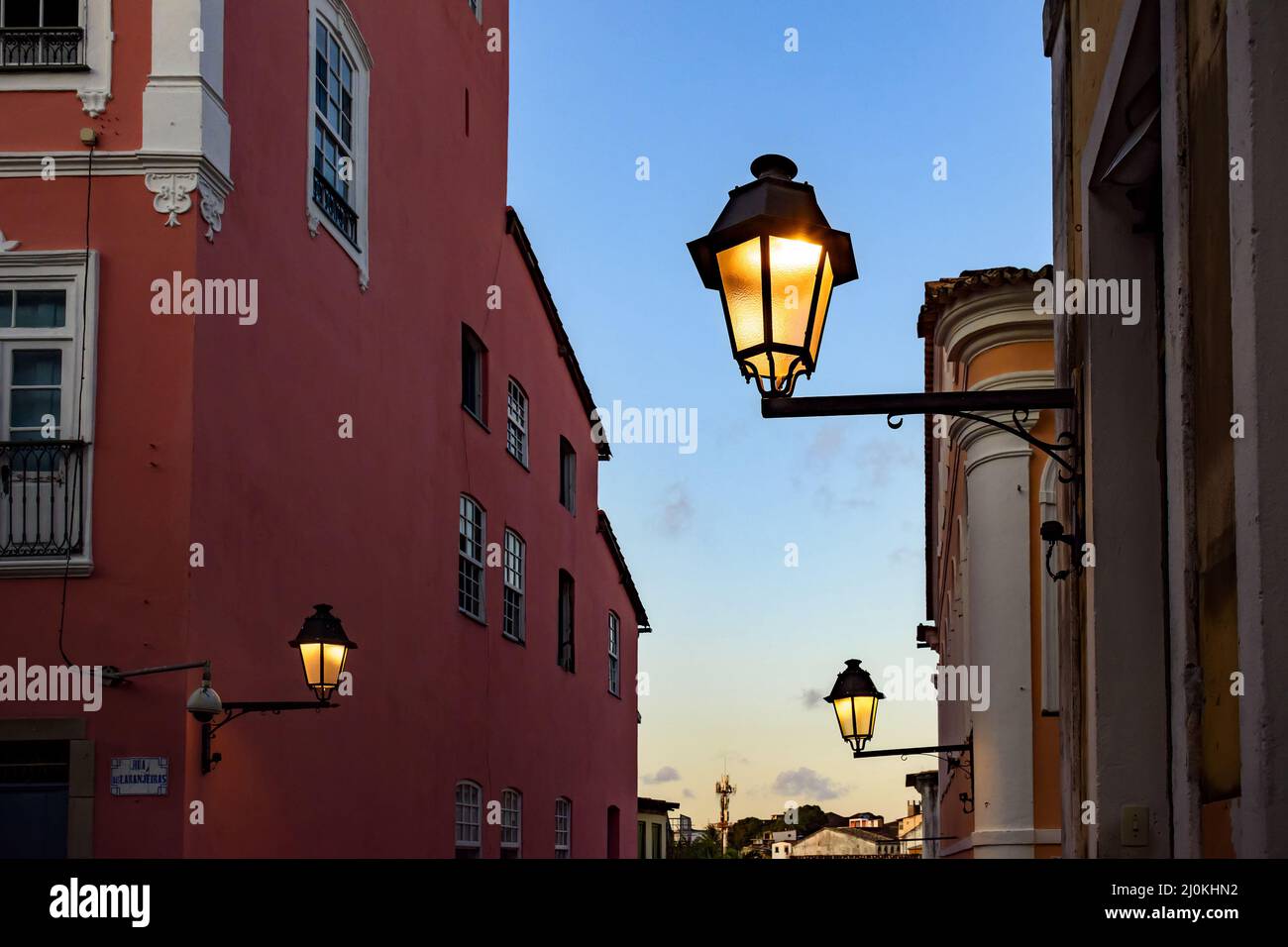 Old iluminated metal lanterns and facade of a colonial houses in the historic Pelourinho district Stock Photo