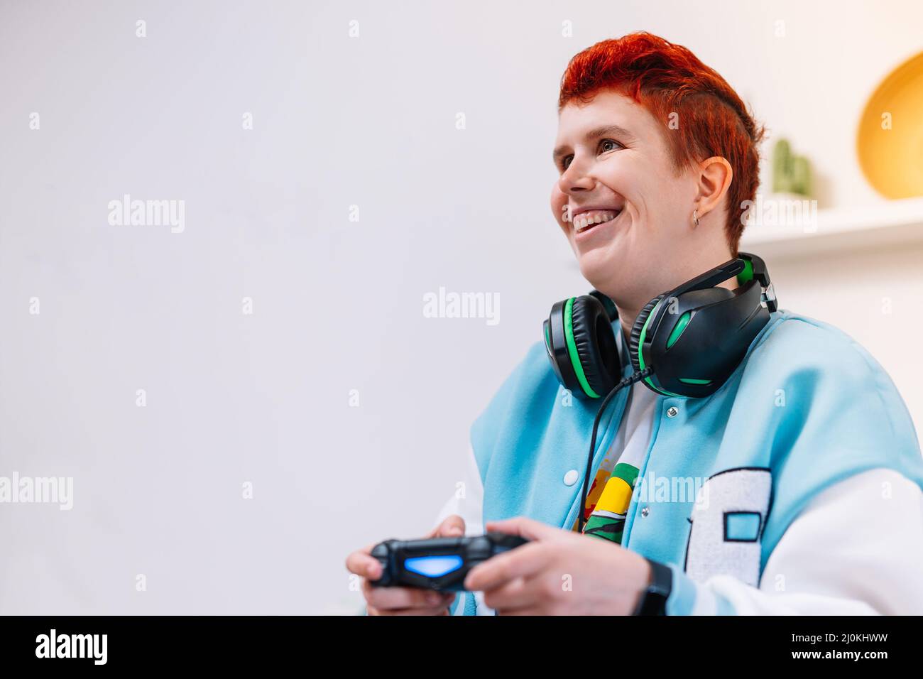 Young modern woman playing video games in the living room Stock Photo