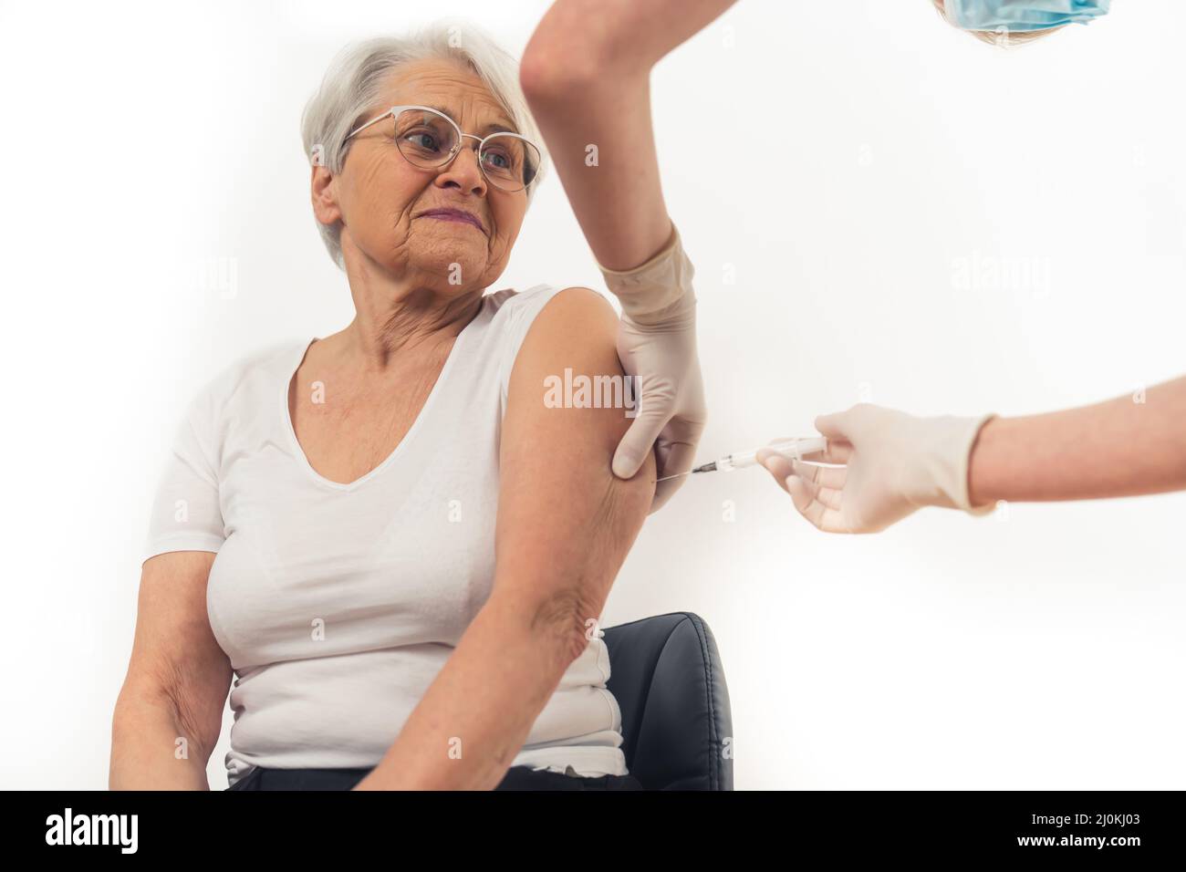 Worried pensioner lady decides to get anti coronavirus vaccine. Responsible senior concept. High quality photo Stock Photo