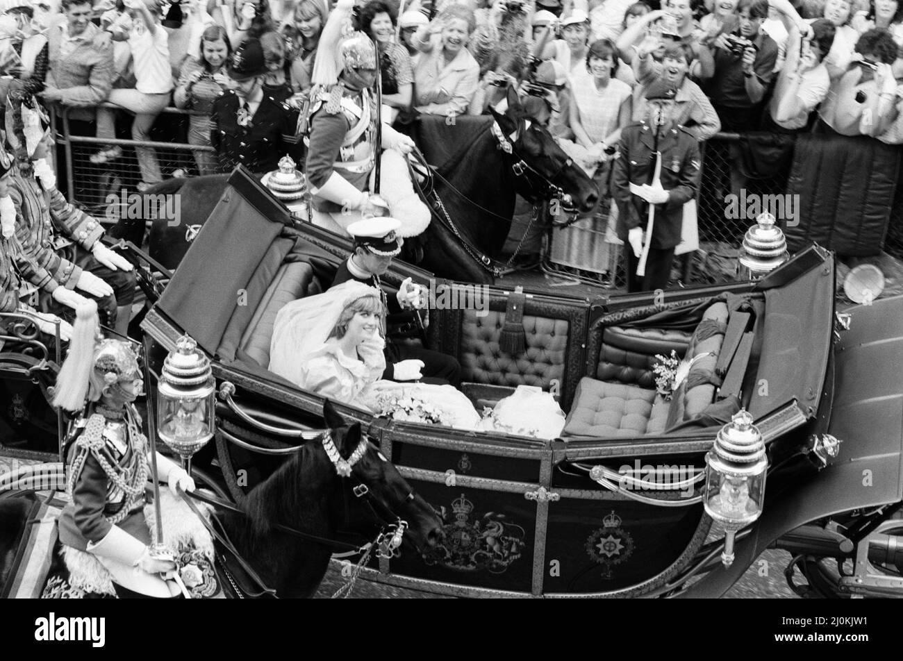HRH Prince Charles marries Lady Diana Spencer.Picture shows the happy couple, having left St Paul's Cathedral, and now riding by carriage to Buckingham Palace.  Lady Diana's wedding dress, and it's 25 foot train has gone down as one of the most famous wedding dresses in history.  The dress was designed by David and Elizabeth Emanuel.  Picture taken 29th July 1981 Stock Photo