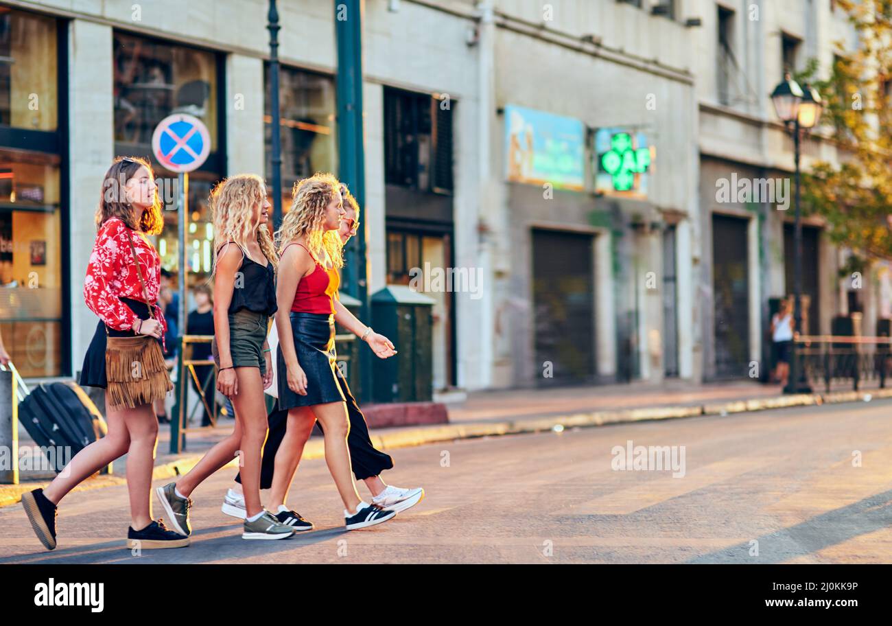 Girls just wanna have fun. Full length shot of a group of attractive young girlfriends taking a walk through the city. Stock Photo